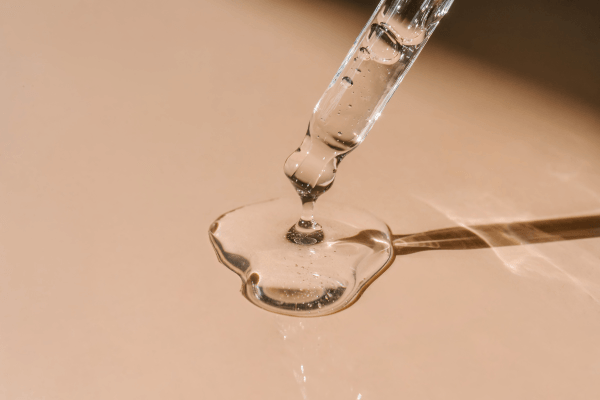 skincare serum dropper on skin