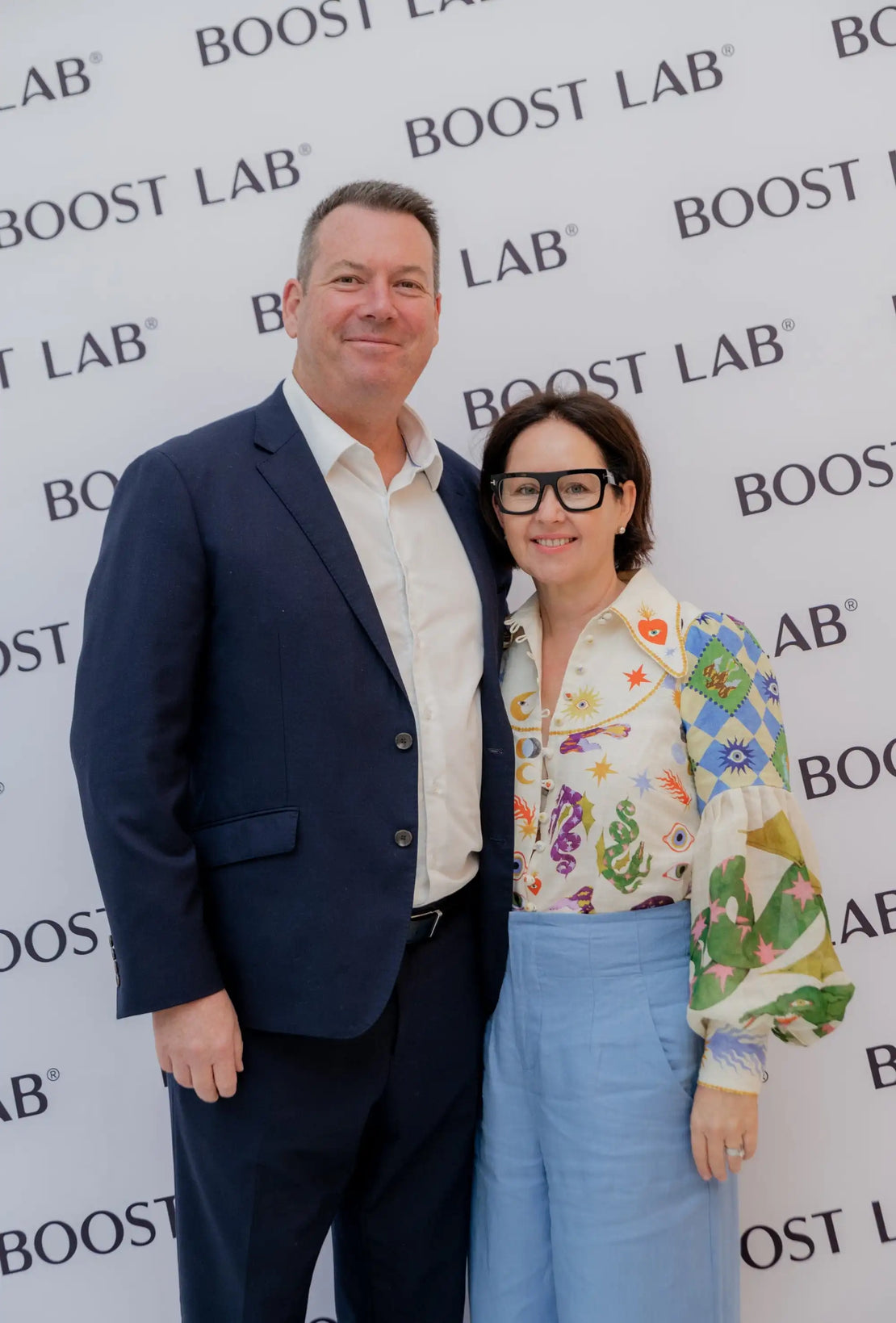 Founder's posing for a photo in front of a 'Boost Lab' branded background.
