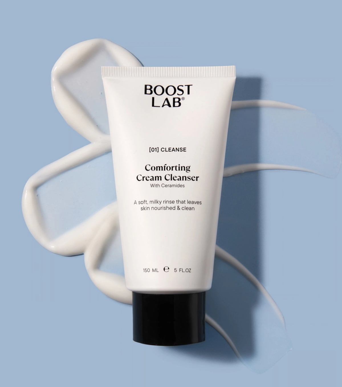 Boost Lab Comforting Cream Cleanser tube with a swirl of milky cream cleanser texture on a blue background